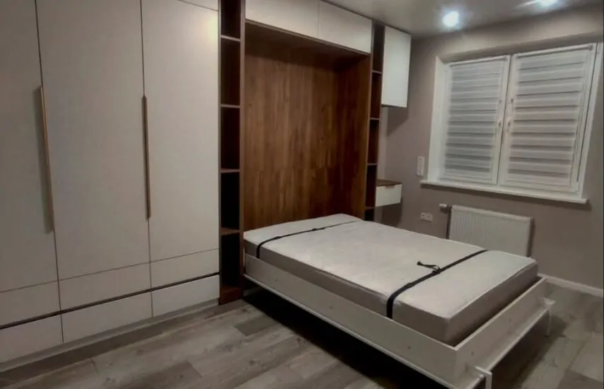 Кровать-трансформер с зоной хранения одежды для спальни